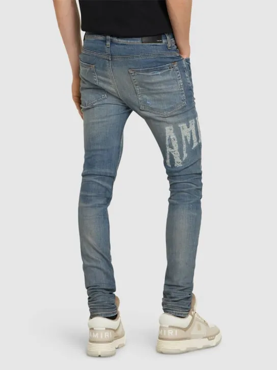 Amiri   Amiri logo distressed jeans 