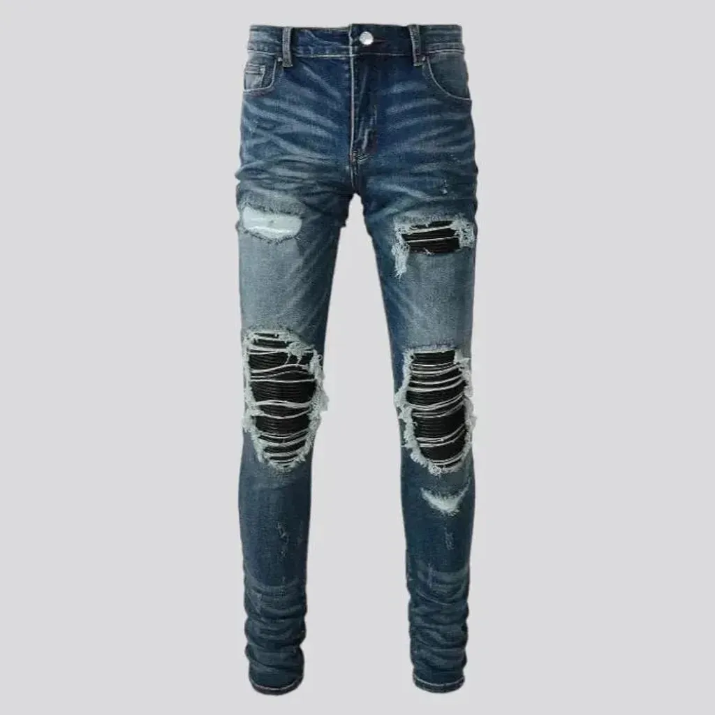Medium-wash men's black-patch jeans